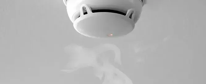 A photo of a smoke alarm comparing flame detectors to smoke alarms.